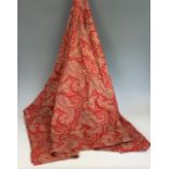 An antique red paisley printed cotton bed spread, of Art Nouveau influence, having clusters of boteh