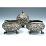 An Indian three-piece white metal cruet set, comprising pepperette and two salt cellars of