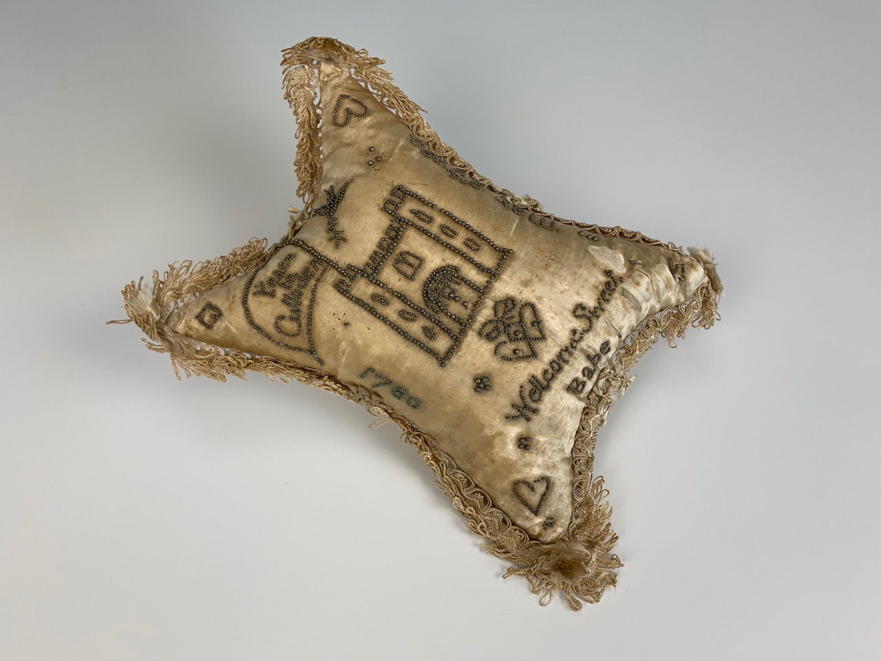 A George III Scottish layette silk pin cushion from Culloden House, decorated with pins in depiction