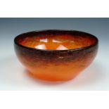 A Monart bubble-included speckled tangerine glass bowl, with grey-black achromatising rim, paper
