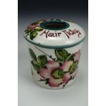 A Wemyss Ware hair tidy, of cylindrical form, hand-enamelled in depiction of rosehip blossom,