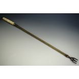 A Victorian carved ivory handled brass toasting fork, 53 cm