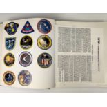 An album of space exploration commemorative mission and other stickers / patches