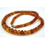 A single-strand graded necklace of sun spangled amber beads, largest approximately 12 mm, smallest 6