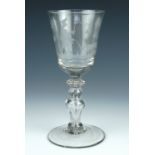 An 18th Century European soda glass wine glass, its bowl wheel cut in depiction of a perambulating