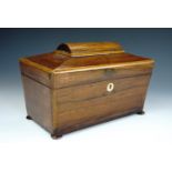 A Victorian rosewood tea caddy, of sarcophagus form, raised on four compressed bun feet, opening