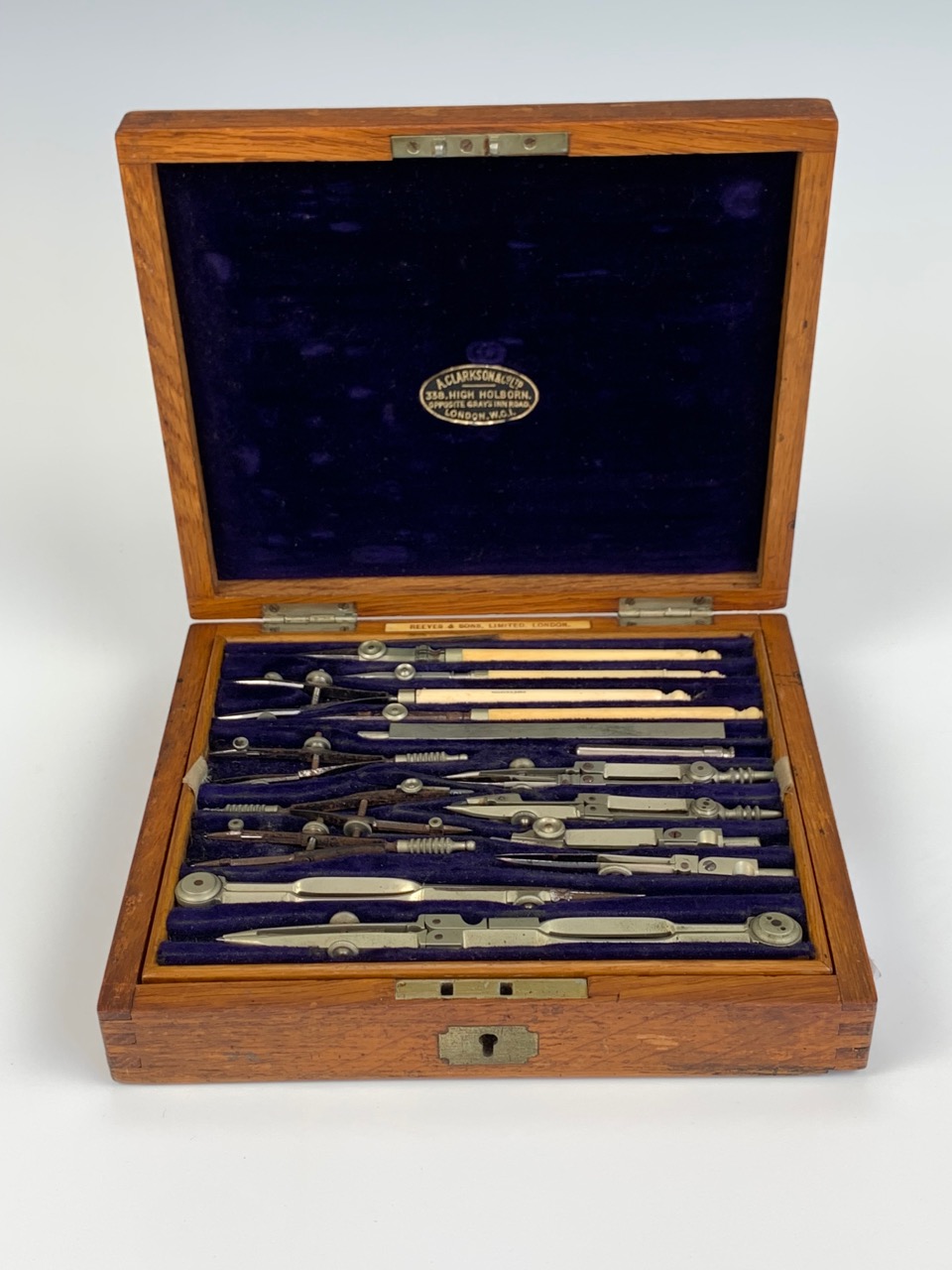 A late Victorian oak-cased set of draughtsman's drawing instruments by Reeves & Sons Ltd of
