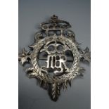 An antique Provincial Scottish white-metal plaid brooch, of openwork design, having a central