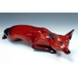 Royal Doulton Flambe Ware fox, modelled in a crouching position, 33 cm in length, free from material