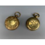 Two antique brass sovereign cases, each with foliate engraved covers, each opening to reveal