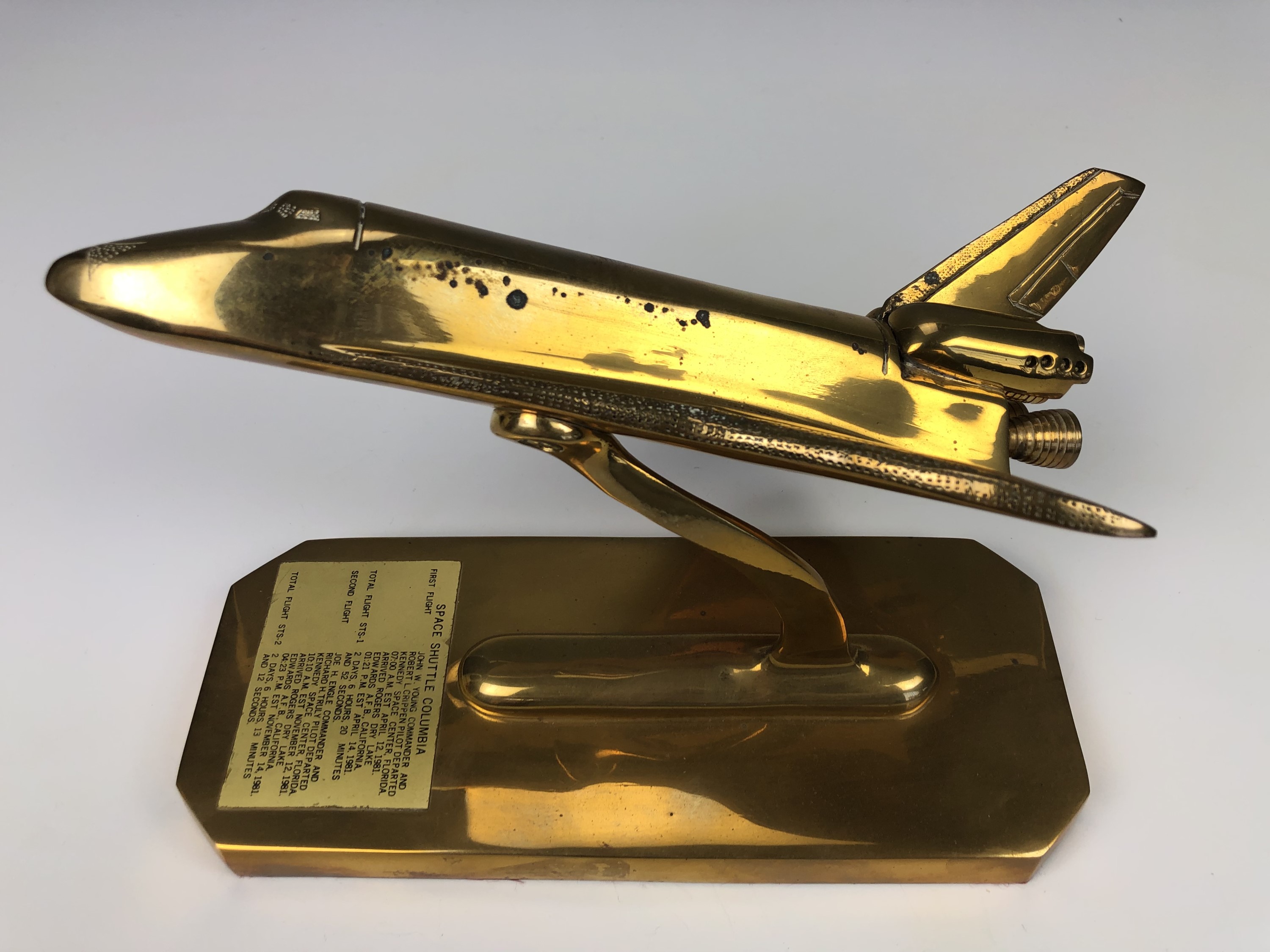 A brass desk model of the Space Shuttle Columbia, 24 cm x 10 cm x 17 cm high