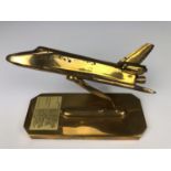 A brass desk model of the Space Shuttle Columbia, 24 cm x 10 cm x 17 cm high