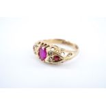 An early 20th Century ruby and diamond ring, the oval face sunken-set with a central oval ruby of