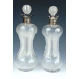 A pair of late Victorian silver-collared kutrolf decanters, each finely ribbed and having conforming
