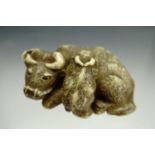 A Meiji Japanese carved ivory netsuke modelled as a water buffalo and calf, 4 cm
