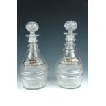 A pair of late Georgian Prussian bodied cut-glass decanters, having triple-ring necks and bearing