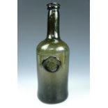 A late 18th Century glass wine or whisky bottle bearing a Culloden seal, 26 cm [The Forbes of