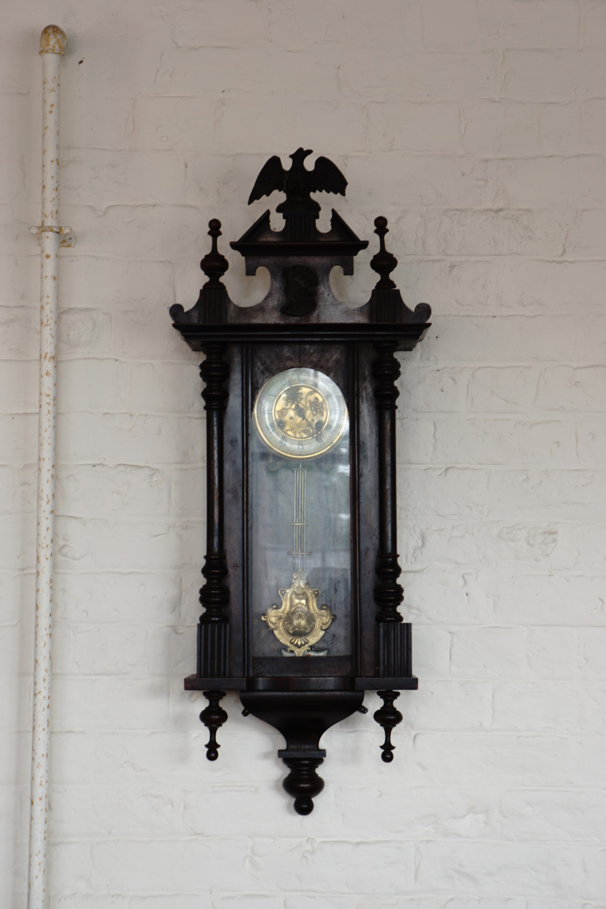 A late 19th / early 20th Century Vienna wall clock with eagle surmount