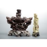 A large Chinese carved soapstone incense burner modelled as temple guardians and pups, together with