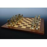 A die-cast "Trojan" style chess set and wooden board, king's 9 cm, board 45 cm