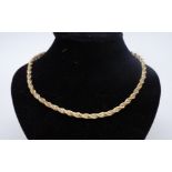 A two-colour 9 ct gold fancy rope link necklace, comprising a heavy cable of yellow gold entwined by