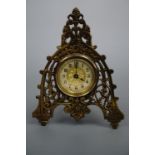 A late 19th Century British United Clock Company brass strut clock, 16 cm, (a/f)