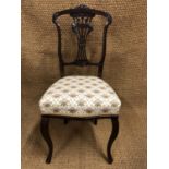 A late Victorian bedroom chair, having a slender-spindle back with pierced splat