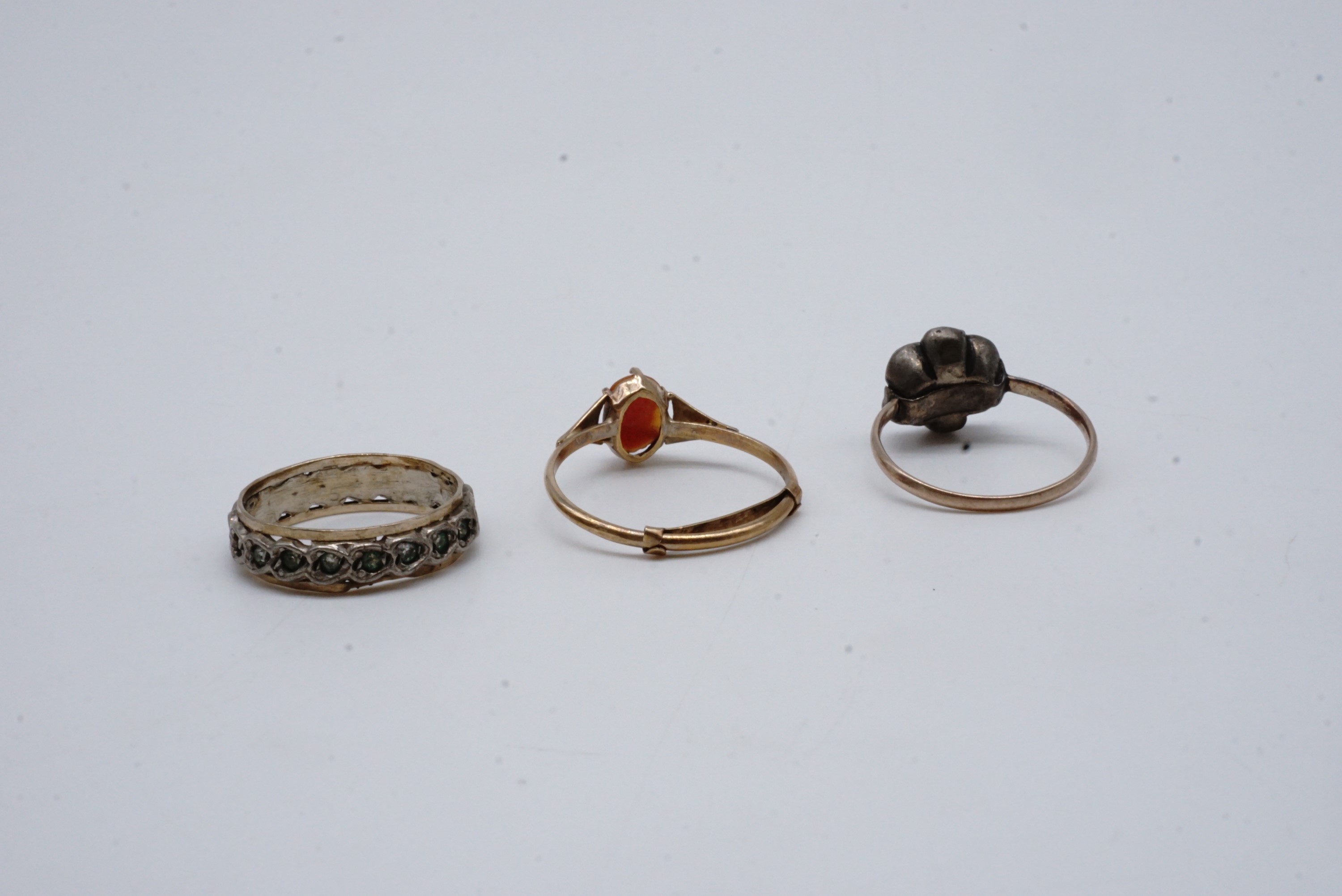 Three vintage yellow metal rings, one with a carved shell cameo claw set to the face, one eternity - Image 2 of 2