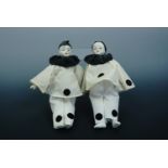 A pair of late 19th / early 20th Century cloth-bodied porcelain Pierrot dolls, 21 cm