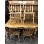 A contemporary reproduction Victorian pine kitchen table together with four Windsor type chairs, one