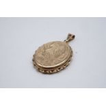 A 9 ct gold oval pendant locket, decorated with floral engraving, 4 cm x 3 cm, 8.8 g total gold