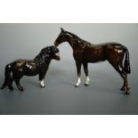 A Beswick Shetland pony, 1033, together with a Beswick hunter horse figure, tallest 21 cm