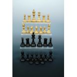 A late 19th / early 20th Century turned wooden chess set, Kings 9.5 cm