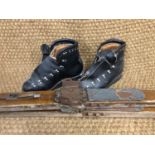 A set of vintage wooden skis and ski boots
