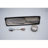 A silver 1919 enameled London souvenir tea spoon together with a silver napkin ring and a silver