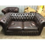 A dark brown deep-button-upholstered hide Chesterfield sofa and armchair, sofa 165 cm wide, 88 cm