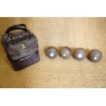 Four vintage crown green bowls together with a later set of Henselite bowls, a case and bowling