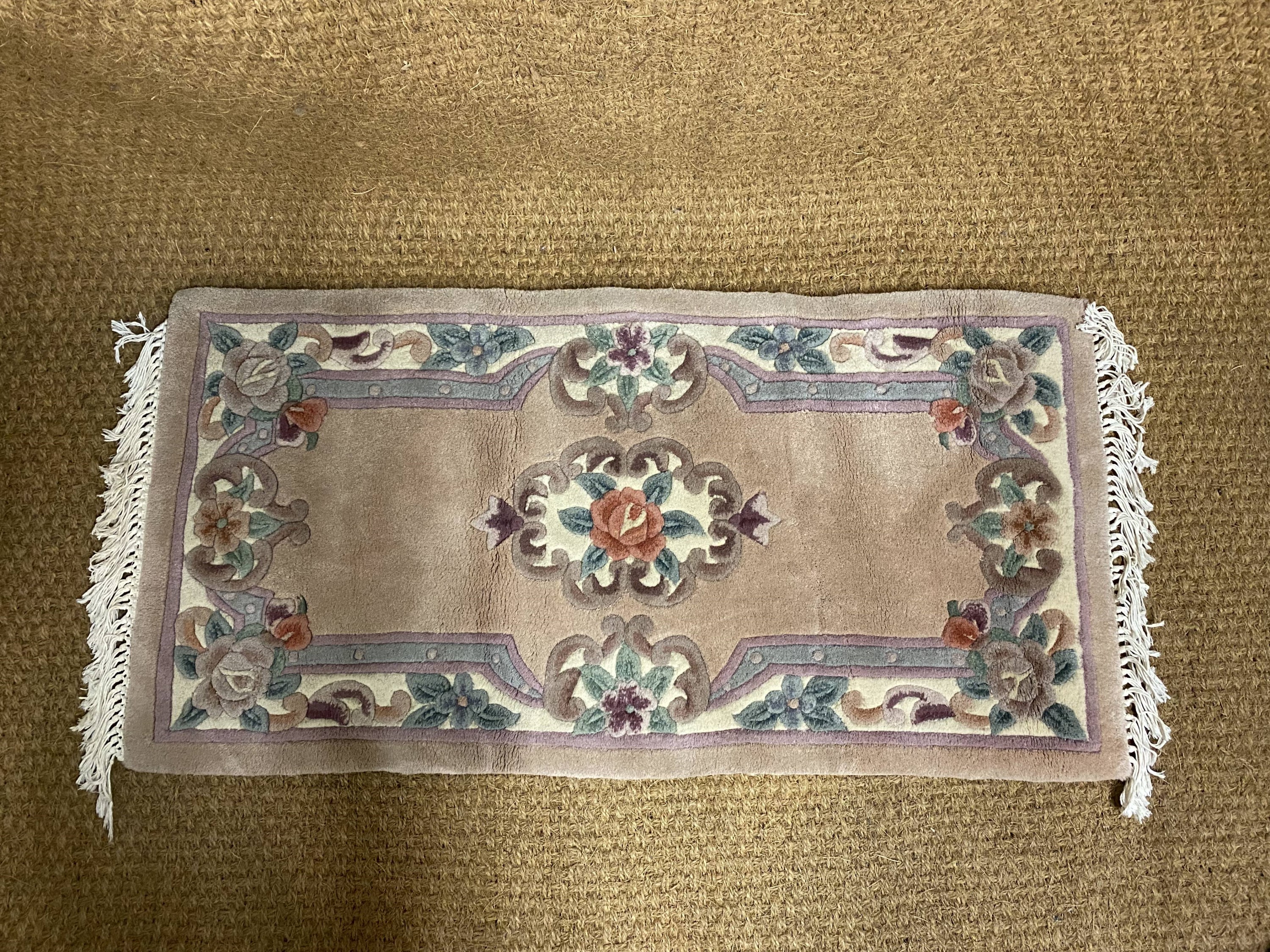A Chinese wool rug, 125 x 62 cm