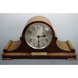 An oak "Napoleon's hat" mantle clock with 1924 presentation plaque, 53 cm