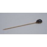 A Victorian sapphire, diamond and yellow metal stick pin, the pendeloque cut sapphire