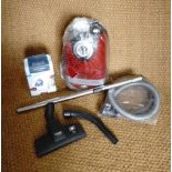 A Miele cylinder hoover and accessories