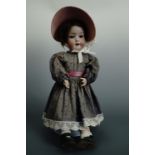 A late 19th / early 20th Century Heubach porcelain doll, having an open mouth and sleeping eyes,