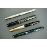 Four Parker fountain pens including a green pearl example