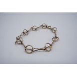 A yellow metal bracelet of spherical cage links divided by cable-links, stamped 375, tested as gold,