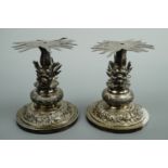 A pair of late 19th Century Chinese white metal tazza or similar stands modelled as dragons,