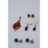 A group of contemporary white metal and other pendants and earrings including a sun spangled amber