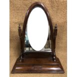 A Victorian rosewood swivel toilet mirror, having an arched bevel-edged mirror plate and base