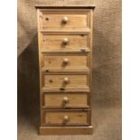 A contemporary pine slender chest of drawers, 55 cm x 45 cm x 123 cm