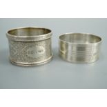 A Victorian engraved silver napkin ring together with a later engine-turned example