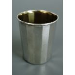 A Millennium silver shot beaker, of faceted cylindrical form, the interior gilt, 48 mm, 22 g
